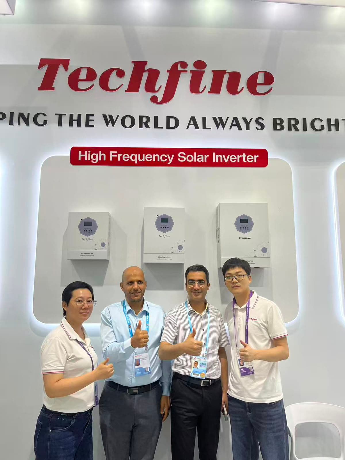 Renewable energy equipment team beside solar inverters