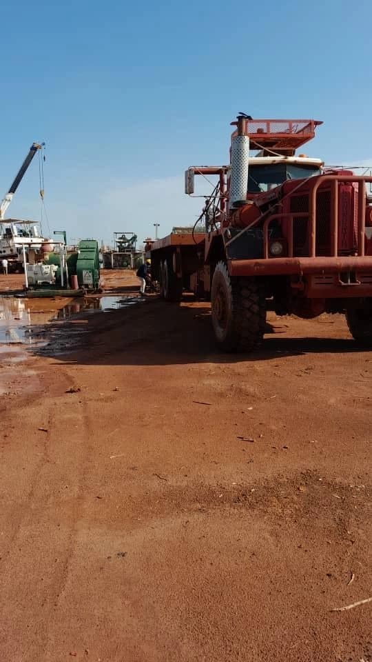 Heavy field equipment positioned inside an operational yard
