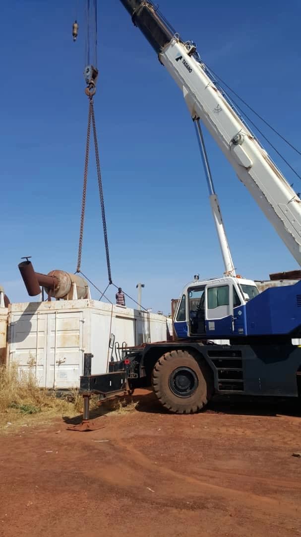 Mobile crane handling operational equipment at a field location